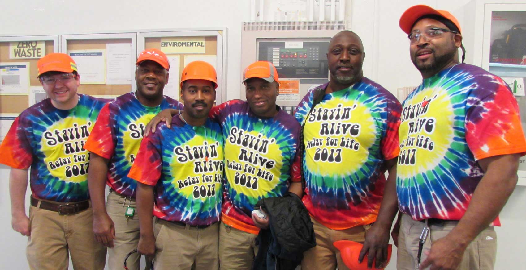 Associates with tie dye Relay for Life shirts on and hard hats