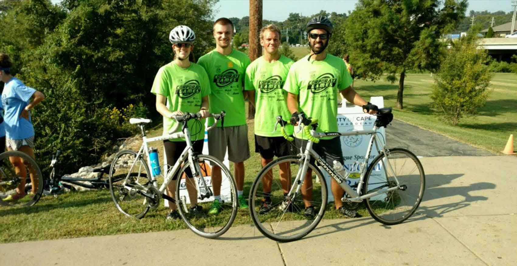 Associates standing next to their bicycles at Corporate Games event
