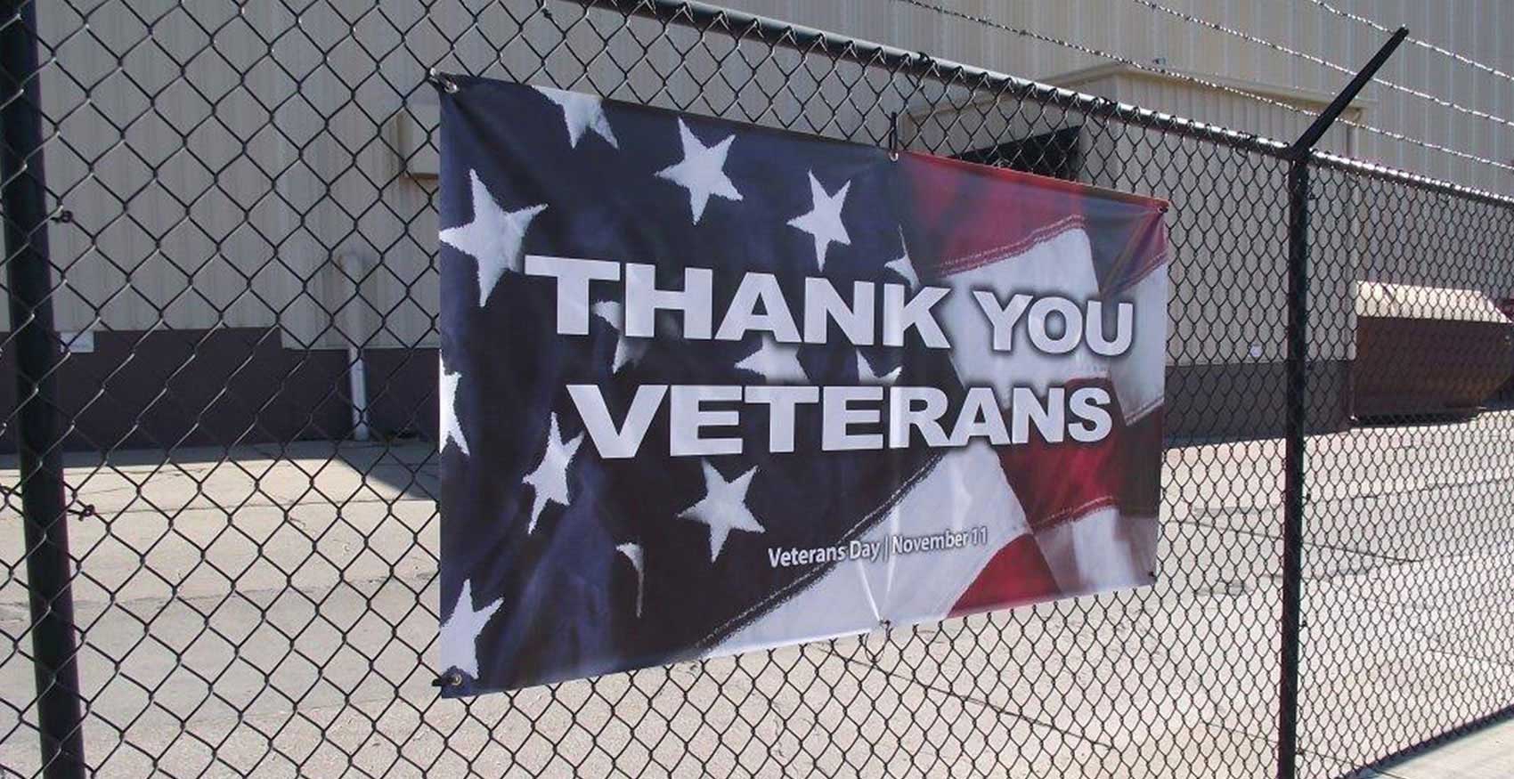 Thank You Veterans banner hanging on fence