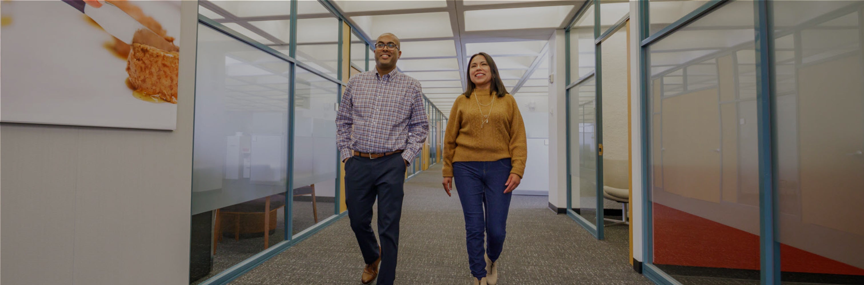 Two contractor employees walking down the hallway