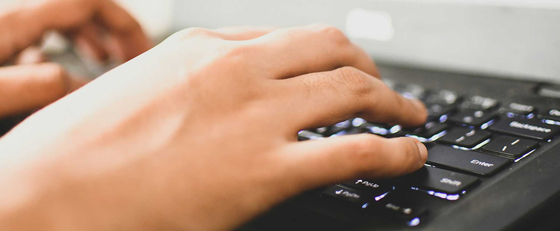 hands typing on keyboard