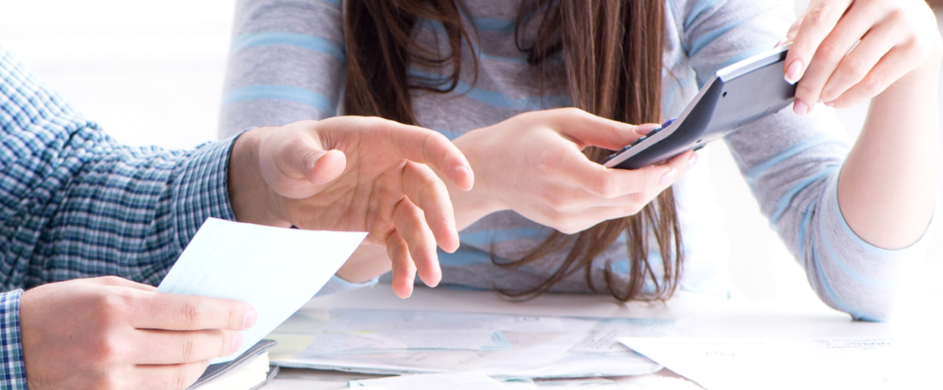 Associates reviewing financial wellness benefits with calculator