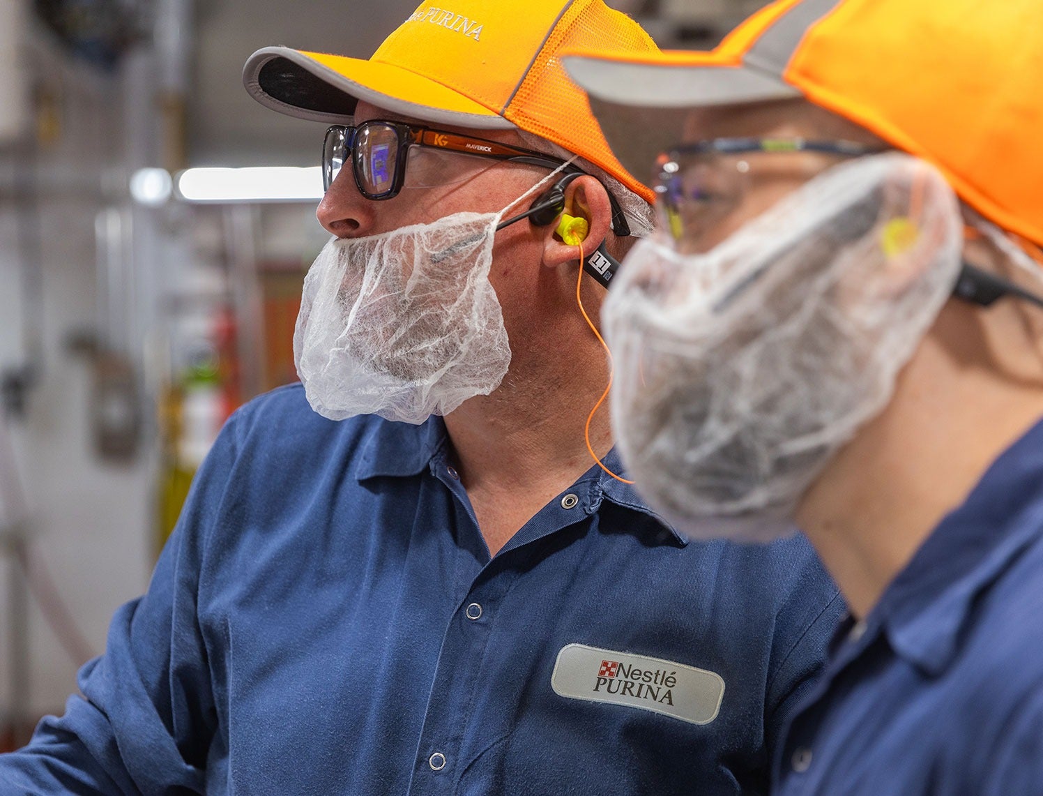 Purina factory workers talking in factory