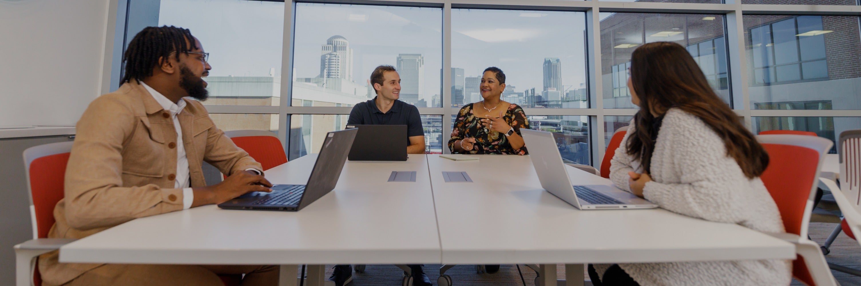 Purina employees meeting conference room with large windows showing city in background