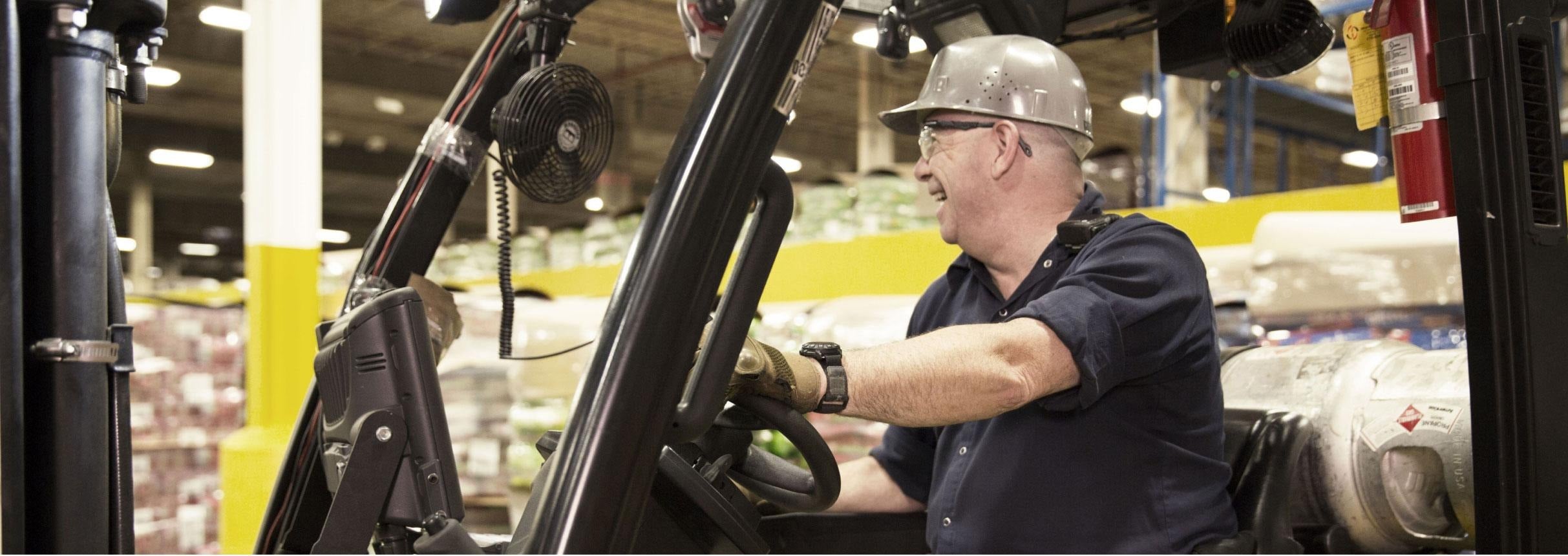 Man driving forklift in warehouse