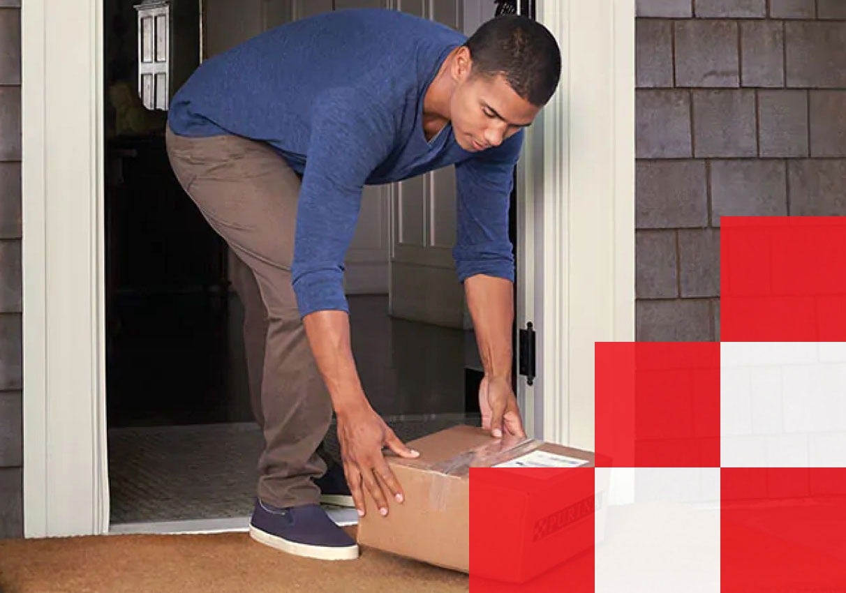 Man picking up box off front porch