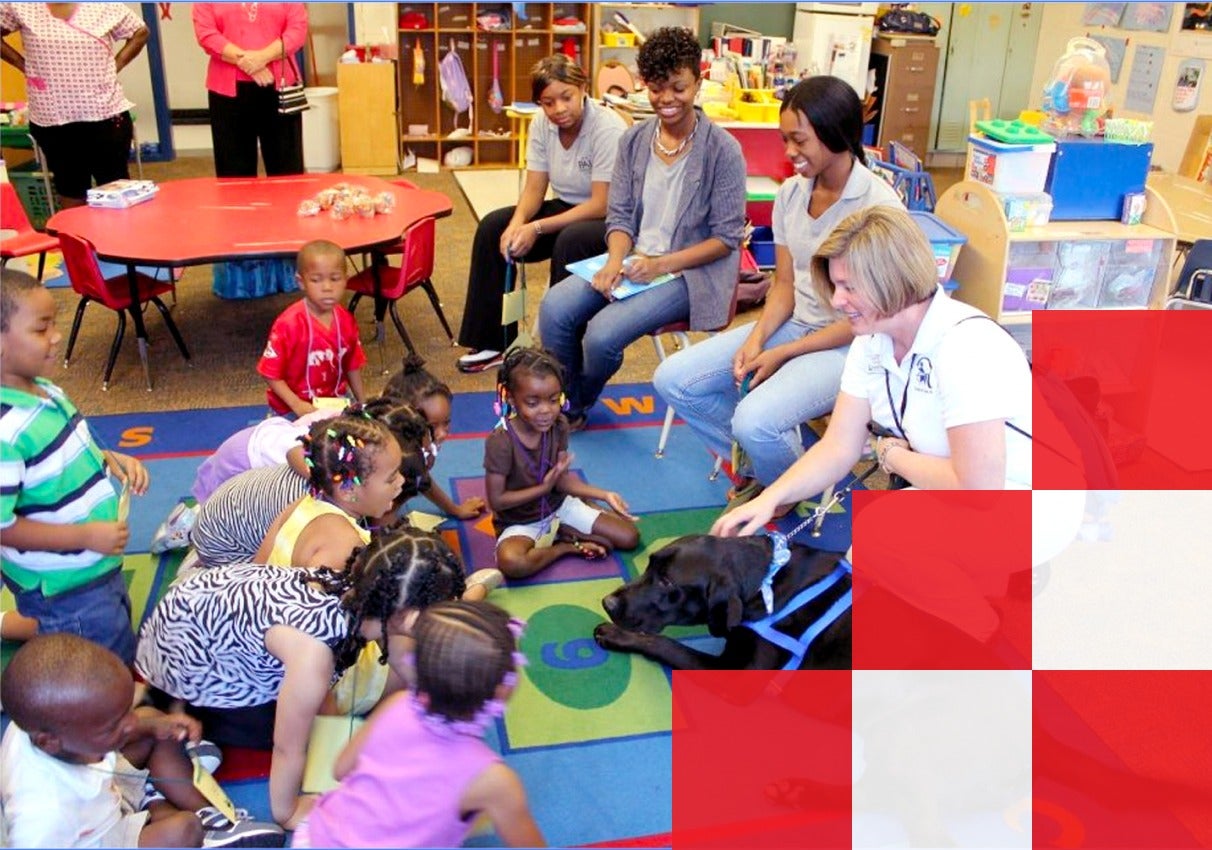 Children and adults gather on the floor, engaging together