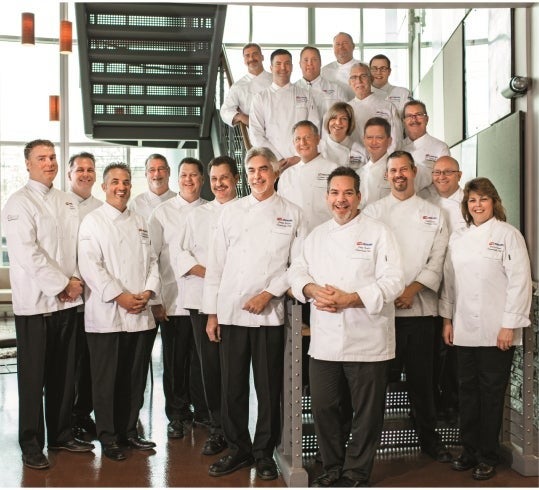 Group of Nestlé chefs smiling and posing together