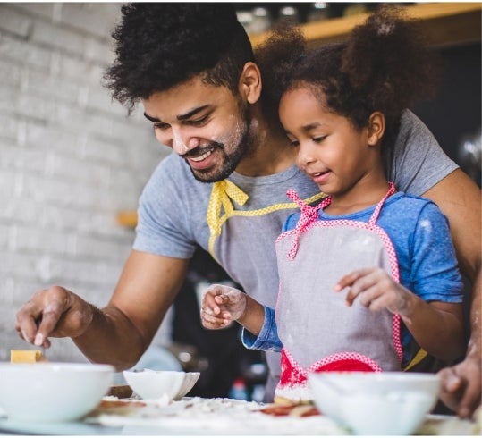 Father and daughter baking together