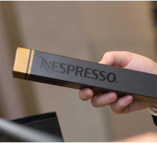 Hand holding nespresso box