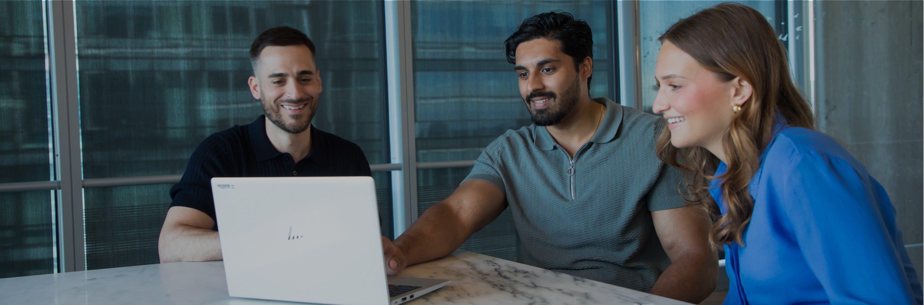 3 Nestle USA employees meeting around a laptop