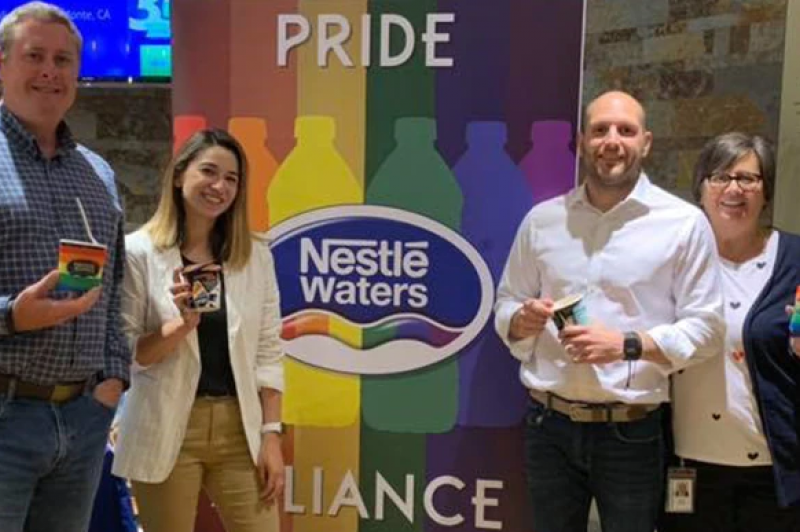 Nestlé employees smiling at the camera  