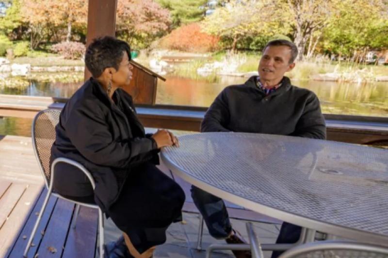 Employees talking by pond