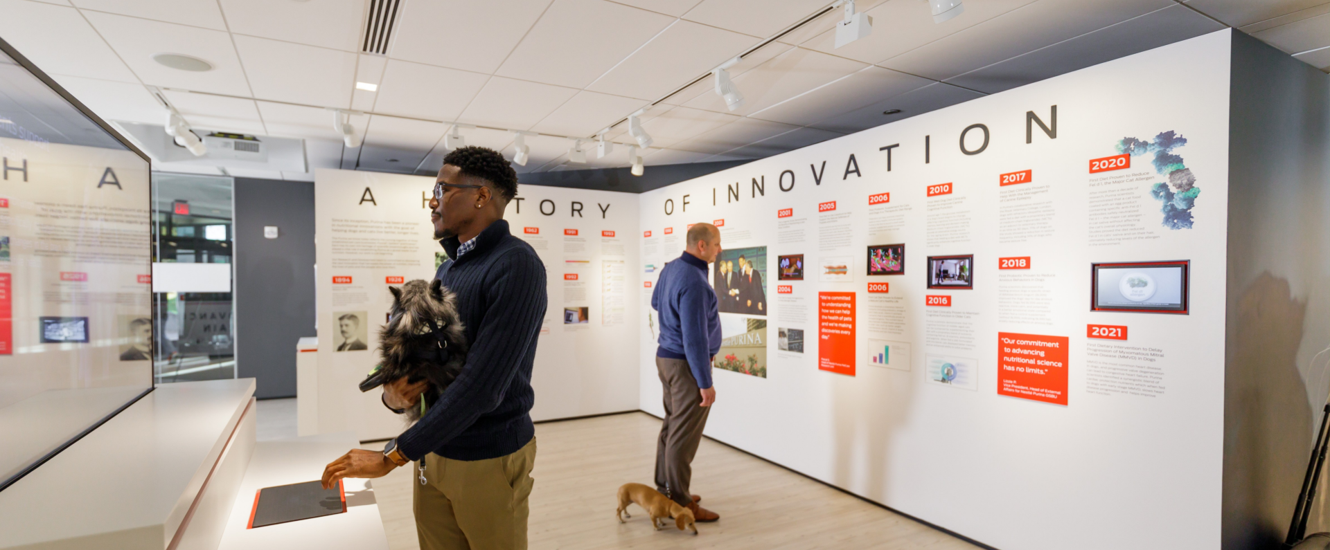 People exploring the Purina history wall